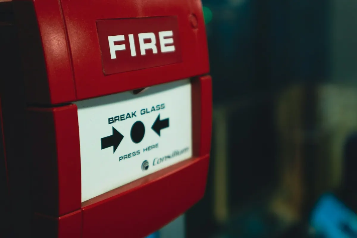 Manual fire alarm call point on a wall